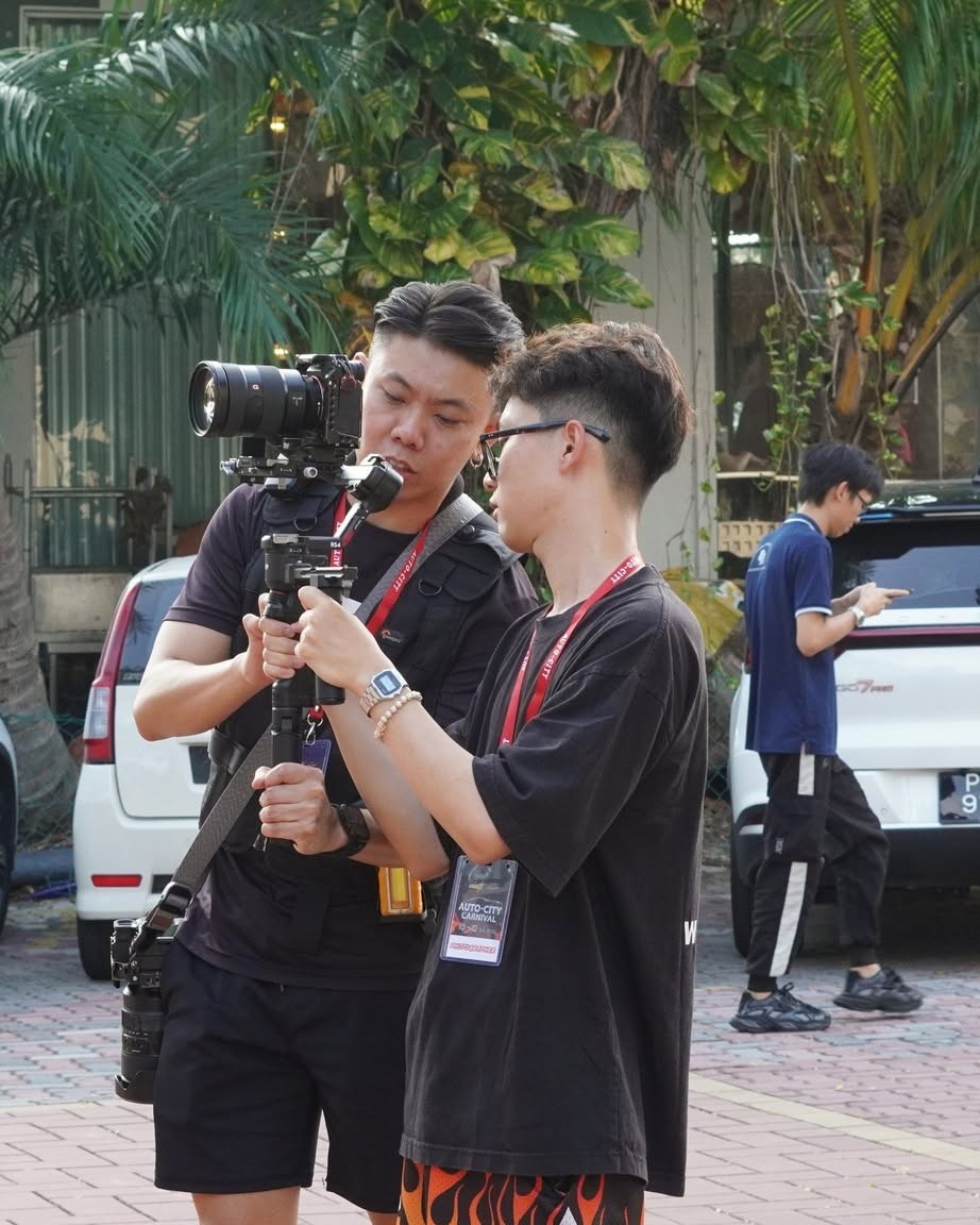 911 Production crew operating a gimbal camera rig on location at Auto-City Carnival